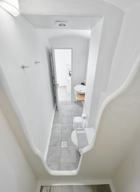 View from the walk-in shower across the bathroom's grey stone floor