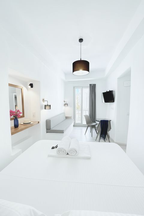 View from the bed towards the sofa, dining table and balcony door